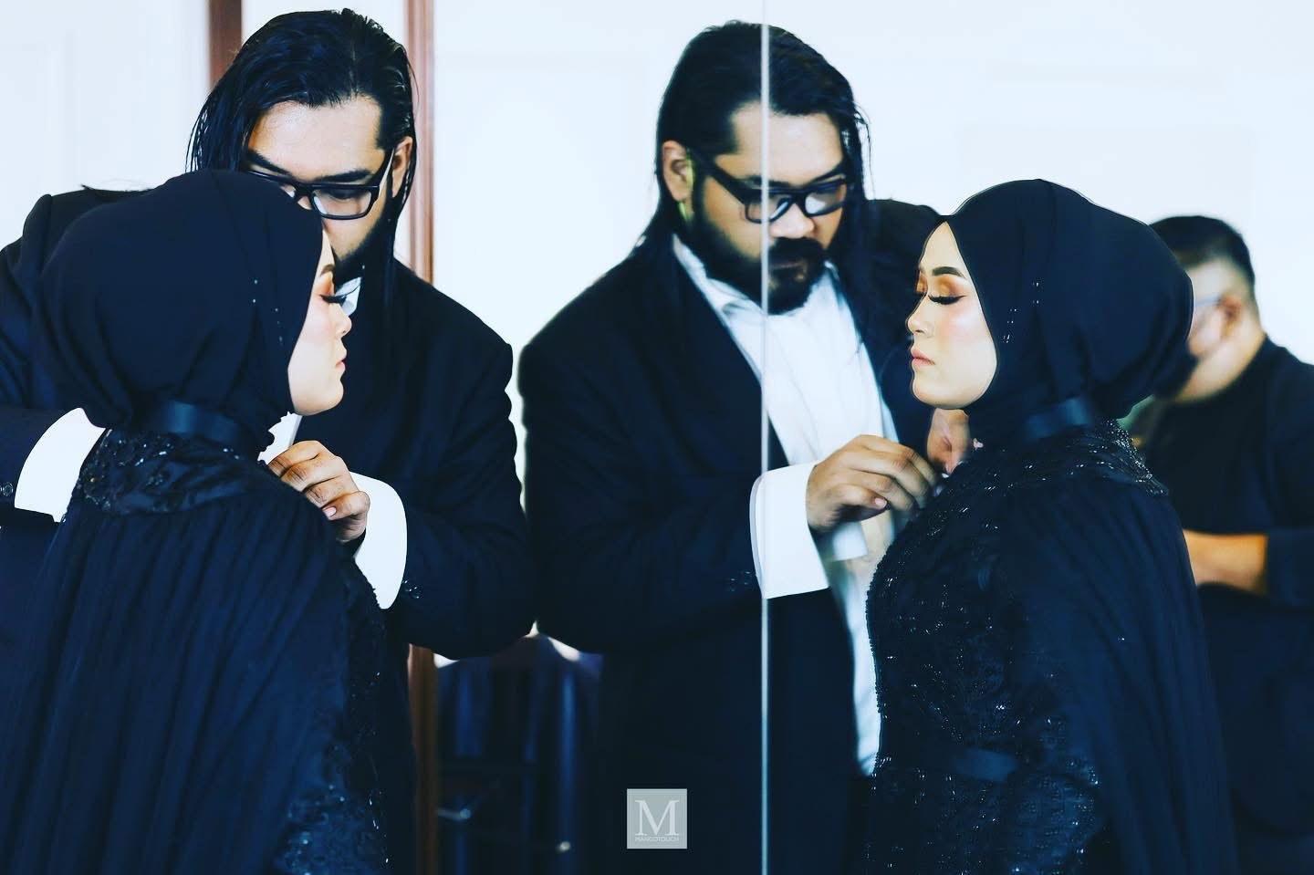 Azhar Zainal fitting a beaded gown on a client in the atelier